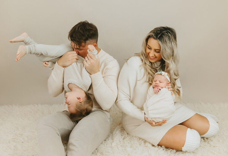 parents and sibling with newborn baby