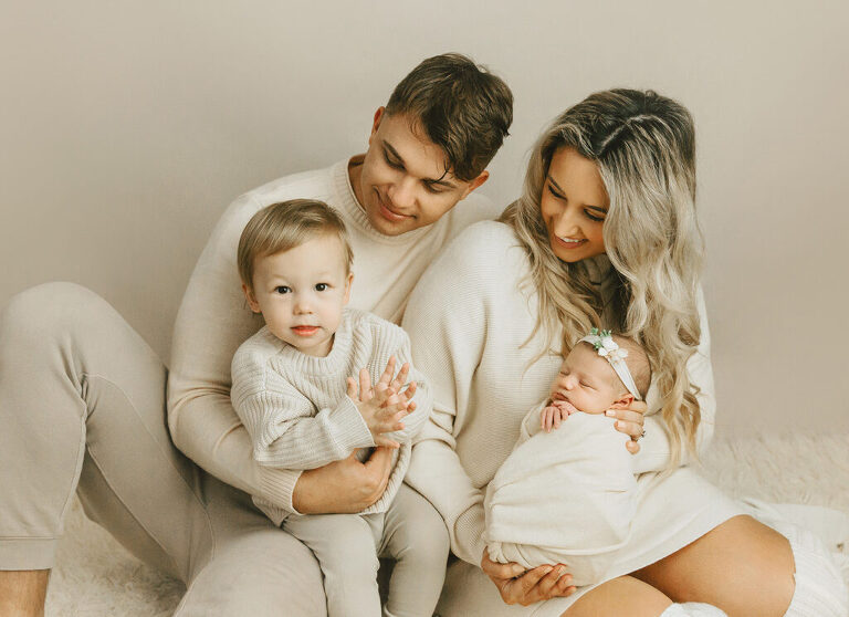parents and sibling with newborn baby