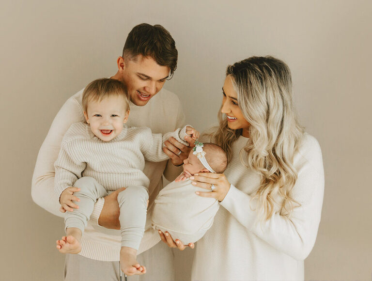 parents and sibling with newborn baby