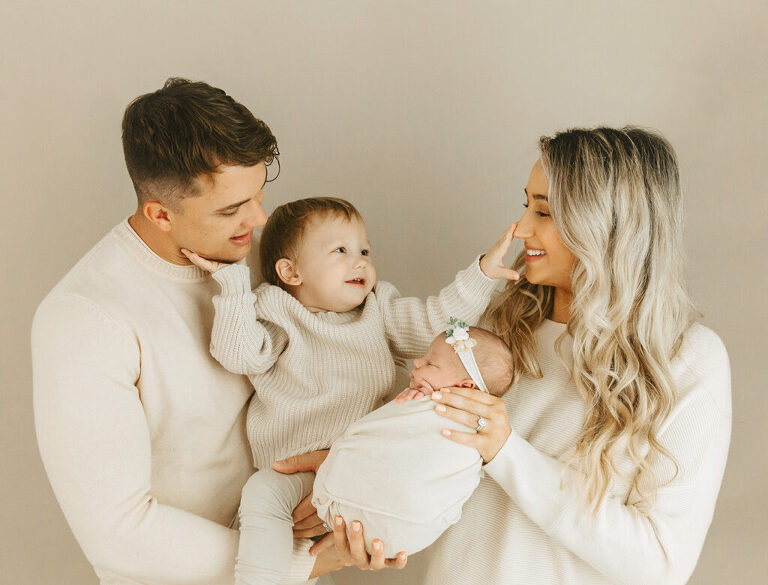 parents and sibling with newborn baby
