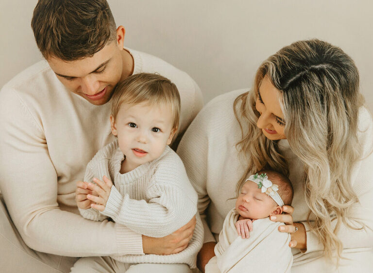 parents and sibling with newborn baby